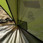 A fabric mesh pock in the corner of a green tent.
